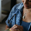 A woman sawing an Aerende brass dish